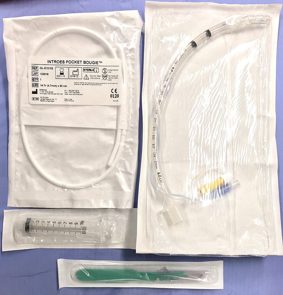 Packaged cricothyrotomy items: a 14 Fr pocket bougie, a 6.0 cuffed tube, a 10 mL syringe and a green scalpel