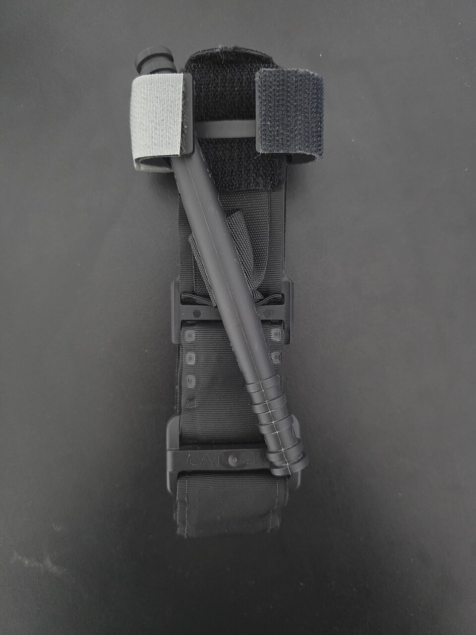 Black Combat Application Tourniquet Gen 7 showing the strap, windlass rod and buckle
