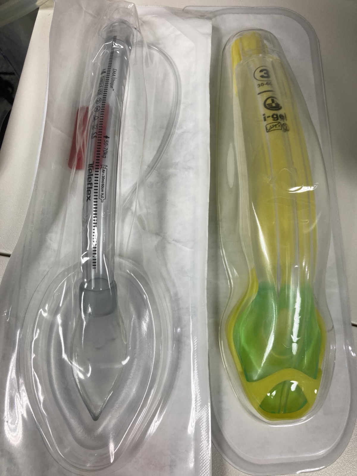 LMA Unique cuffed device in its pack beside an i-gel size 3 in its pack; the LMA label (size 4 shown) gives the maximum cuff air volume and 60 cm H2O