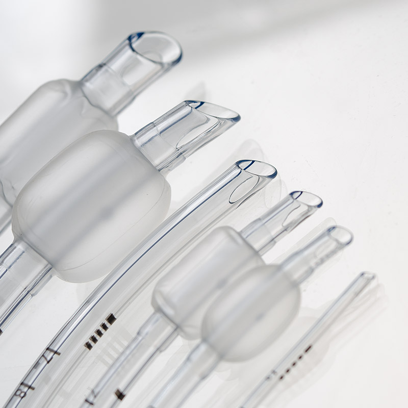 Several clear endotracheal tubes with inflatable cuffs and depth markings